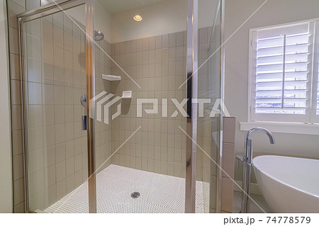 Modern tiled glass shower cubicle bright interior 74778579