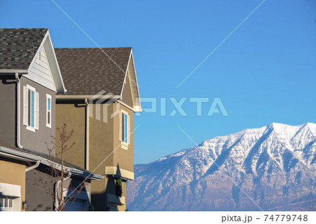 View of houses against mountains on sunny day 74779748