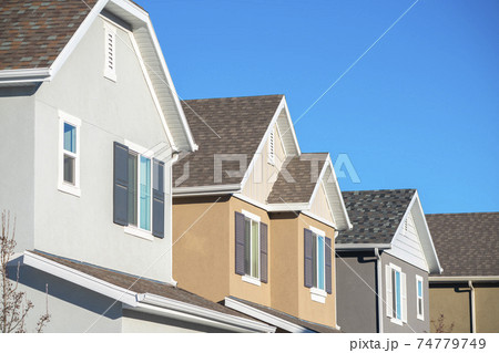 Row of upper floor house facades with shutters 74779749