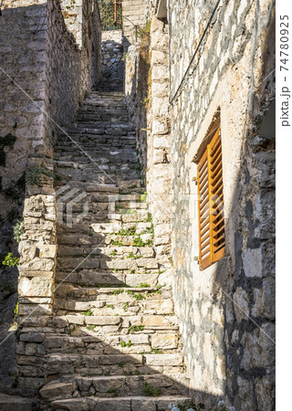 Street with stone stairs leading to the hill in Skradin town, Croatia Street with stone stairs leading to the hill in Skradin town, Croatia 74780925