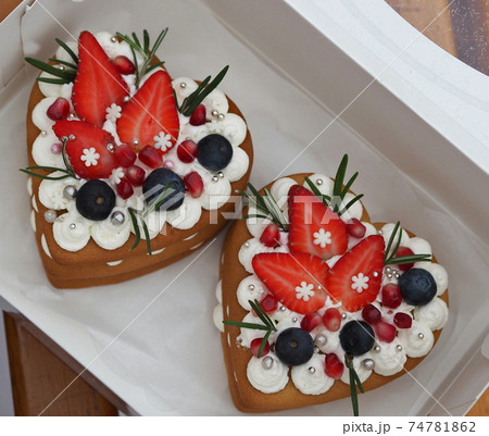Gift in a box, two heart shaped cakes for Valentine is Day. Food congratulatory background. Gift in a box, two heart shaped cakes for Valentine is Day. Food congratulatory background. 74781862