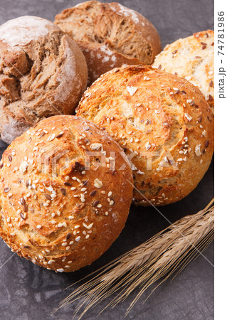 Wholegrain rolls with seeds and ears of rye or wheat grain 74781986