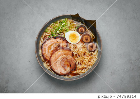 A Shoyu Ramen in gray bowl on concrete table top. Japanese cuisine meat noodle soup with chashu pork 74789314
