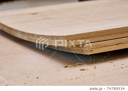 Glued curved oak wood panels extreme closeup view. Furniture manufacture Glued curved oak wood panels extreme closeup view. Furniture manufacture 74789334