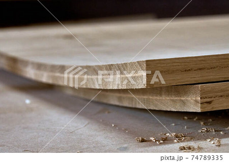Glued curved oak wood panels extreme closeup view. Furniture manufacture 74789335