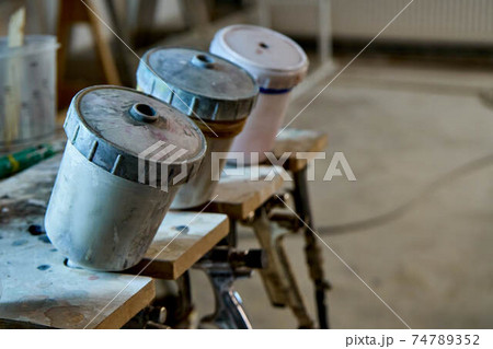 Painting chamber, spray gun. Furniture manufacture. Close-up Painting chamber, spray gun. Furniture manufacture. Close-up 74789352