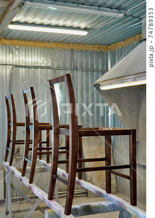 Stool frame of dark wood timber in painting booth Stool frame of dark wood timber in painting booth 74789353