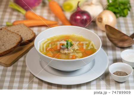 Fresh Vegetable soup in a white bowl , Traveling 74789909