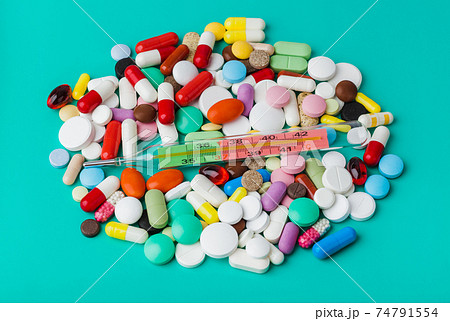 Pills and thermometer - medical background Pills and thermometer - medical background 74791554