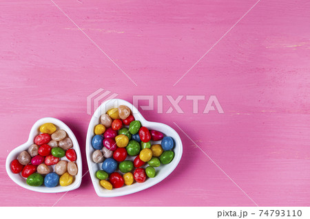 Multicolored candies in a plate in the shape of a heart Multicolored candies in a plate in the shape of a heart 74793110