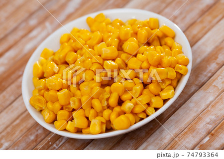 Close up of preserved maize in plate on table 74793364