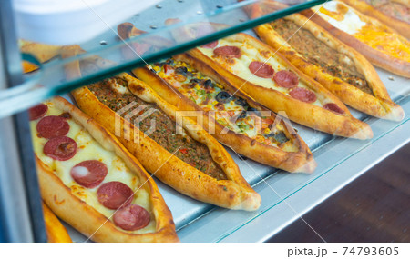 Traditional Turkish pide with various fillings on bakery showcase 74793605