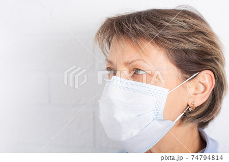 Elderly caucasian woman wearing medical face mask. Elderly caucasian woman wearing medical face mask. 74794814