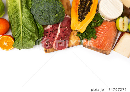 Vitamin A in food isolated on white background. Top view. Copy space 74797275