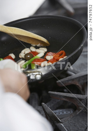 Midsection Of Chef Cooking Food Midsection Of Chef Cooking Food 74797652