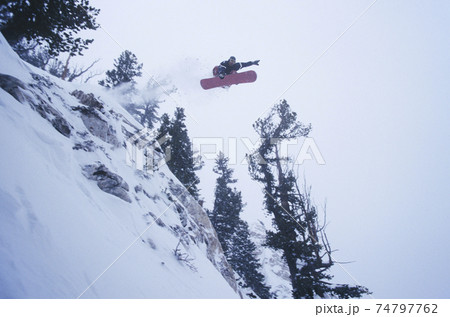 Person On Snowboard Jumping Midair 74797762