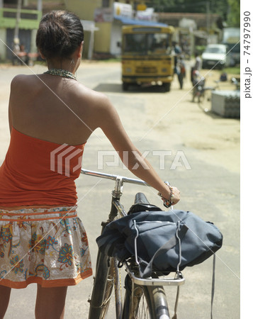 Woman Walking With Bicycle On Street Woman Walking With Bicycle On Street 74797990