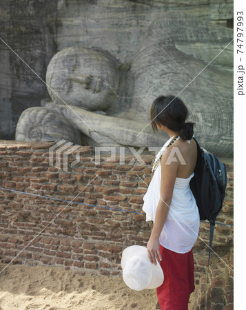 Woman Looks At Sleeping Buddha Statue Woman Looks At Sleeping Buddha Statue 74797993