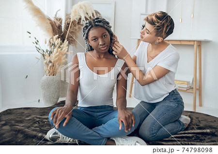 Girls spending time at home trying on some accessories 74798098