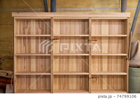 Ash veneered mdf bookcase in workshop. Wooden furniture Ash veneered mdf bookcase in workshop. Wooden furniture 74799106