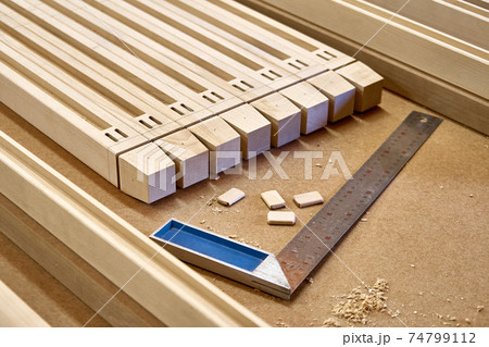 Wooden furniture legs folded on workbench in workshop 74799112