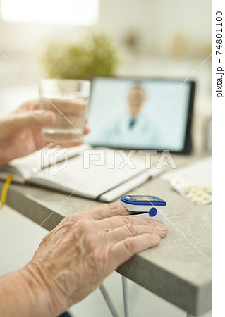 Senior citizen measuring vitals and consulting doctor online from home Senior citizen measuring vitals and consulting doctor online from home 74801100