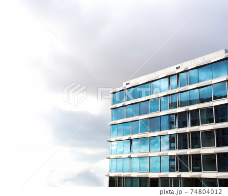 glass buildings,skyscraper with cloudy moody white sky background, Modern Office Building,modern architecture with copy space, business,abstract and design concept 74804012