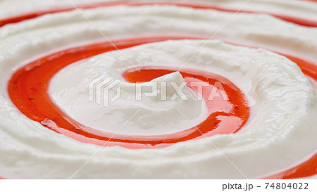Yogurt with fruit jam, curd cream swirl with berry topping 74804022