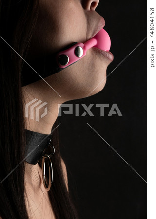 Beautiful woman in the role of a slave on black background 74804158