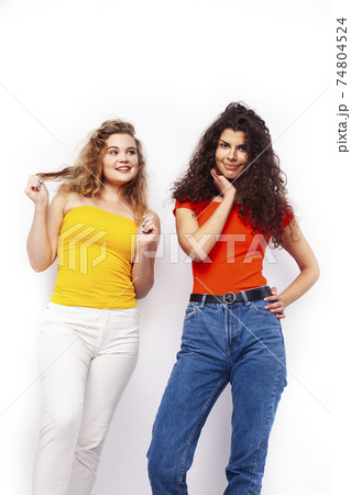 young pretty teenage girls friends with blond and brunette curly hairs posing cheerful isolated on white background, lifestyle people concept young pretty teenage girls friends with blond and brunette curly hairs posing cheerful isolated on white background, lifestyle people concept 74804524