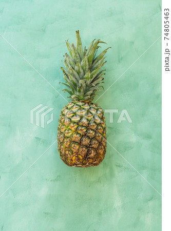 Whole pineaple fruit on green background, top view 74805463