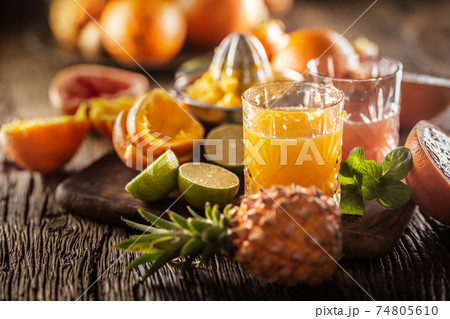 Fresh homemade juices made from oranges and grapefruits in ornamental glasses 74805610