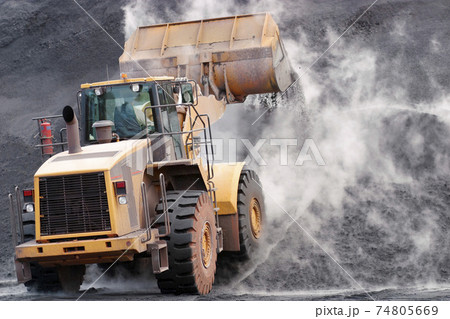 Front loader dumping mineral material on heap Front loader dumping mineral material on heap 74805669