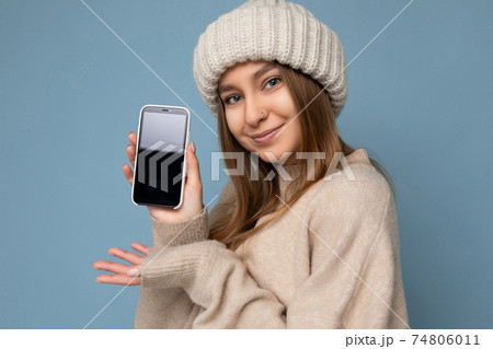 Closeup portrait Photo of sexy smiling beautiful young woman wearing stylish beige sweater and beige Closeup portrait Photo of sexy smiling beautiful young woman wearing stylish beige sweater and beige 74806011