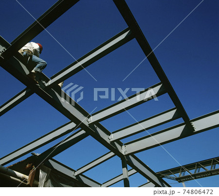 Worker sitting on iron construction low angle view Worker sitting on iron construction low angle view 74806472