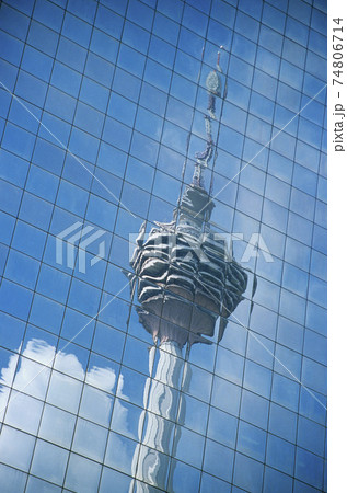 Distorted reflection of Kuala Lumpur Tower in building wall full frame Distorted reflection of Kuala Lumpur Tower in building wall full frame 74806714