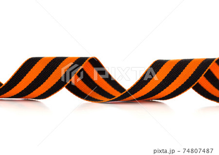 St. George ribbon on a white background. Black orange ribbon close up on a white background. St. George ribbon on a white background. Black orange ribbon close up on a white background. 74807487