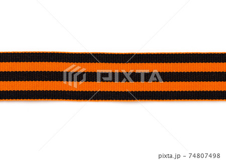 St. George ribbon on a white background. Black orange ribbon close up on a white background. 74807498