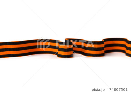 St. George ribbon on a white background. Black orange ribbon close up on a white background. 74807501