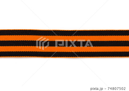 St. George ribbon on a white background. Black orange ribbon close up on a white background. 74807502