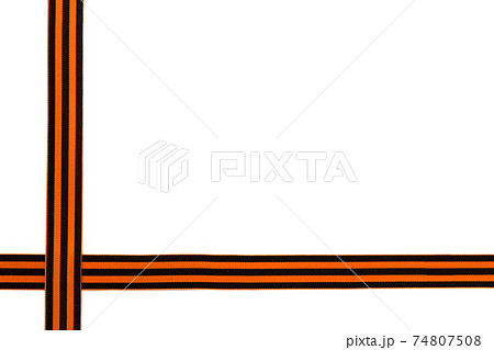 St. George ribbon on a white background. Black orange ribbon close up on a white background. 74807508