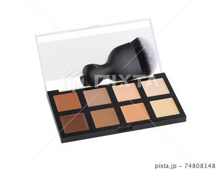 Contouring palette on a white background. Makeup palette of several colors and brush close-up. Contouring palette on a white background. Makeup palette of several colors and brush close-up. 74808148
