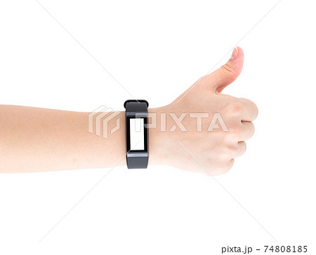 Fitness bracelet on a female hand. Fitness tracker closeup on hand isolated on white background. Thumb raised up. Blank display. Fitness bracelet on a female hand. Fitness tracker closeup on hand isolated on white background. Thumb raised up. Blank display. 74808185
