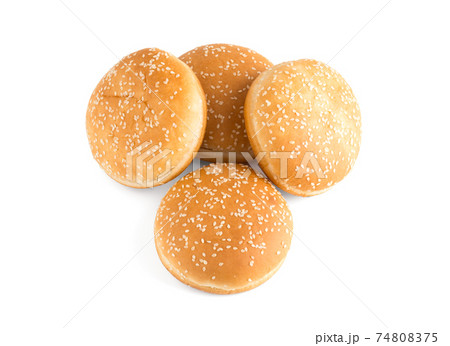 Burger buns on white background. A few buns cut in half close up on a white background. Burger buns on white background. A few buns cut in half close up on a white background. 74808375