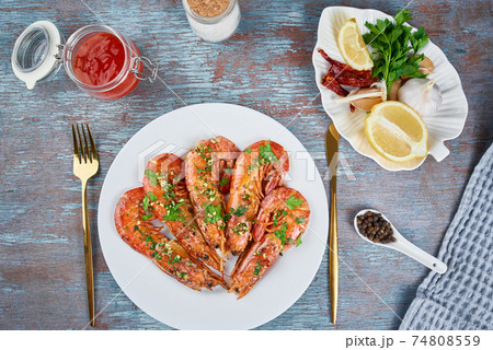 Grilled large queen shrimps with lemon and spices on the plate Grilled large queen shrimps with lemon and spices on the plate 74808559