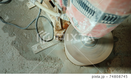 Powerful power tool drills a hole in a concrete ceiling Powerful power tool drills a hole in a concrete ceiling 74808745