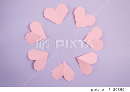 Valentine's day background. Pink hearts laid out in a circle on a pastel purple background. Valentine's day concept. Layout for postcards and congratulations. Flat lay, top view, copy space Valentine's day background. Pink hearts laid out in a circle on a pastel purple background. Valentine's day concept. Layout for postcards and congratulations. Flat lay, top view, copy space 74808994