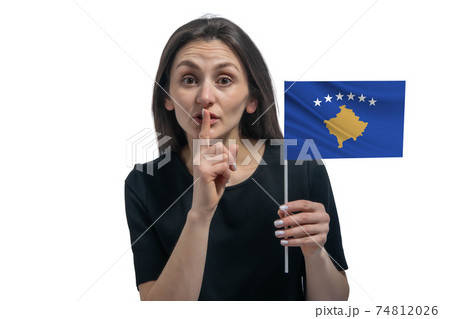 Happy young white woman holding flag of Kosovo and holds a finger to her lips isolated on a white background 74812026