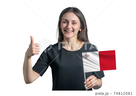 Happy young white woman holding flag of Malta and shows the class by hand isolated on a white background Happy young white woman holding flag of Malta and shows the class by hand isolated on a white background 74812081