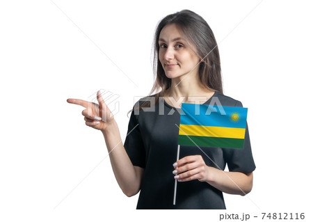 Happy young white woman holding flag Rwanda and points to the left isolated on a white background Happy young white woman holding flag Rwanda and points to the left isolated on a white background 74812116